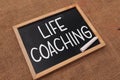 Life coaching, text words typography written on chalkboard against wooden background, life and business motivational inspirational