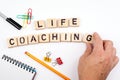 Life coaching. Wooden letters on a white background