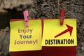 Life destination sign concept with red arrow and inspirational quote - Enjoy your journey, written on yellow memo papernote.