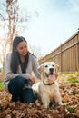 Life is even better with a furry best friend. an attractive young woman having fun with her dog on an autumn day in a Royalty Free Stock Photo