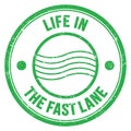 LIFE IN THE FAST LANE text on green round postal stamp sign Royalty Free Stock Photo