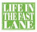 LIFE IN THE FAST LANE, text on green stamp sign Royalty Free Stock Photo