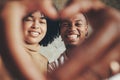 Life is the flower for which love is the honey. Portrait of a young couple making a heart shape with their hands.