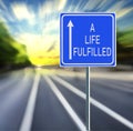 A Life Fulfilled Road Sign on a Speedy Background with Sunset. Royalty Free Stock Photo