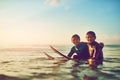 Life is fun when youre out surfing with a buddy. Shot of two young boys out surfing. Royalty Free Stock Photo