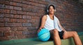 When life gets stressful, I like to play basketball. Portrait of a sporty young man taking a break after a game of Royalty Free Stock Photo