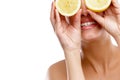 When life gives you lemons...Studio shot of a young woman holding two halves of a lemon in front of her eyes. Royalty Free Stock Photo