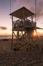 Life guard tower on an empty beach at sunrise.