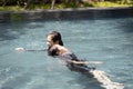 Life guard woman holding sinking child swimming in water,female lifesaver helping girl in summer vacation,first aid for drowning