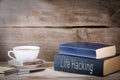 Life Hacking. Stack of books on wooden desk Royalty Free Stock Photo