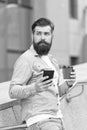 Life happens coffee helps. Hipster hold takeaway coffee outdoors. Bearded man enjoy drinking coffee. Hot cup. Morning