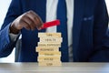 Life happens, insurance helps. an unrecognisable businessman assembling wooden blocks with insurance related words on
