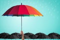 Life-health Insurance protection, business financial leadership concept with leader`s hand holding rainbow umbrella distinctively Royalty Free Stock Photo