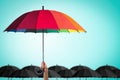 Life-health Insurance protection or business financial leadership concept with leader`s hand holding rainbow umbrella Royalty Free Stock Photo