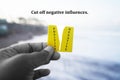 Life inspirational and motivational quote - Cut off negative influences. With person holding yellow torn card in hand.