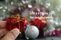 Life inspirational quote - Life is a precious gift. Use your days wisely. With person holding red gift box in hand. Royalty Free Stock Photo