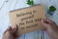 Life inspirational quote text on notepad - Believing in yourself is the first step to success. Royalty Free Stock Photo