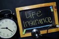 Life Insurance handwriting on chalkboard on top view. Royalty Free Stock Photo