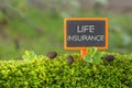 Life insurance text on small blackboard