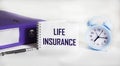 Life insurance word on notepad with clock and folder on white background Royalty Free Stock Photo