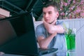 Disabled man with amputated stump hands in cafe talks on video chat on laptop. Royalty Free Stock Photo