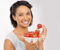 Life is just a bowl of strawberries. Portrait of a young woman enjoying a bowl of strawberries. Royalty Free Stock Photo