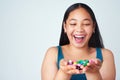 Life just got a little bit sweeter. Studio shot of a cute young girl holding a handful of colorful jelly beans. Royalty Free Stock Photo