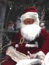Santa Claus with his Christmas list of names Royalty Free Stock Photo