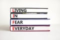 LIFE living in fear everyday symbol. Concept words LIFE living in fear everyday on books on a beautiful white table white Royalty Free Stock Photo