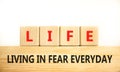 LIFE living in fear everyday symbol. Concept words LIFE living in fear everyday on wooden blocks on a beautiful white background. Royalty Free Stock Photo