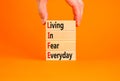 LIFE living in fear everyday symbol. Concept words LIFE living in fear everyday on wooden blocks on an orange background. Royalty Free Stock Photo