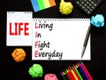 LIFE living in fight everyday symbol. Concept words LIFE living in fight everyday on note on beautiful black background. Black