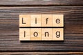 Life long word written on wood block. life long text on table, concept