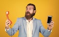 life meets possibilities. mature bearded man with retro phone. male hold smartphone. compare technology. mobile phone vs Royalty Free Stock Photo