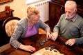 Life partners playing a game of dominos Royalty Free Stock Photo