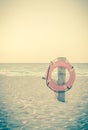 Life preserver on sandy beach Royalty Free Stock Photo