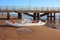 A life raft. a boat stranded or parked on the sandy beach in broad daylight