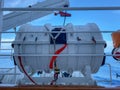 A life rafts on a cruise ship in metal containers waiting to deployed in case of an emergency