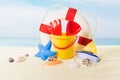 Life ring and beach toys in sand on blue Royalty Free Stock Photo