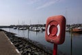 Life saving emergency floatation ring on the side of a marina