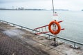 Lifebelt and ladder along a lakeside path Royalty Free Stock Photo