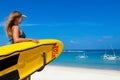 Lifeguard woman stand with surf rescue board on beach