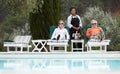 This is the life...A senior couple enjoying champagne at the pool while on vacation. Royalty Free Stock Photo