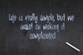 Life is really simple, but we insist on making it complicated - Confucius quote on a blackboard Royalty Free Stock Photo