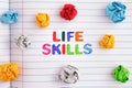 Life Skills. The words Life Skills on a notebook sheet with some colorful crumpled paper balls around them