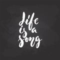 Life is a song - hand drawn Musical lettering phrase isolated on the black chalkboard background. Fun brush chalk vector