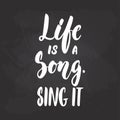 Life is a song. Sing it - hand drawn Musical lettering phrase isolated on the black chalkboard background. Fun brush