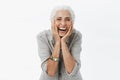 Life only starts when get older. Portrait of charming happy and carefree european senior woman with grey hair laughing Royalty Free Stock Photo