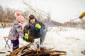 Life Style is a winter family picnic by the campfire. Father and daughter fry sausages by the fire. Family active rest