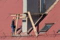 Life-threatening high-altitude work. A team of roofers works on the roof without insurance. Repair of the roof and ventilation Royalty Free Stock Photo